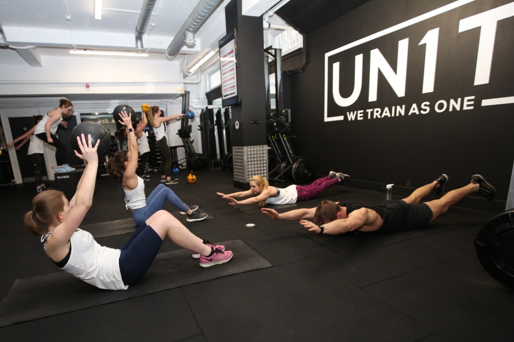 Jockey Fit workout: Sit-us with medicine balls and superman holds at one of the workout stations