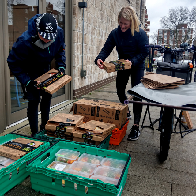 Members of the Made in Hackney and One Planet Pizza teams working together on pizza deliveries.